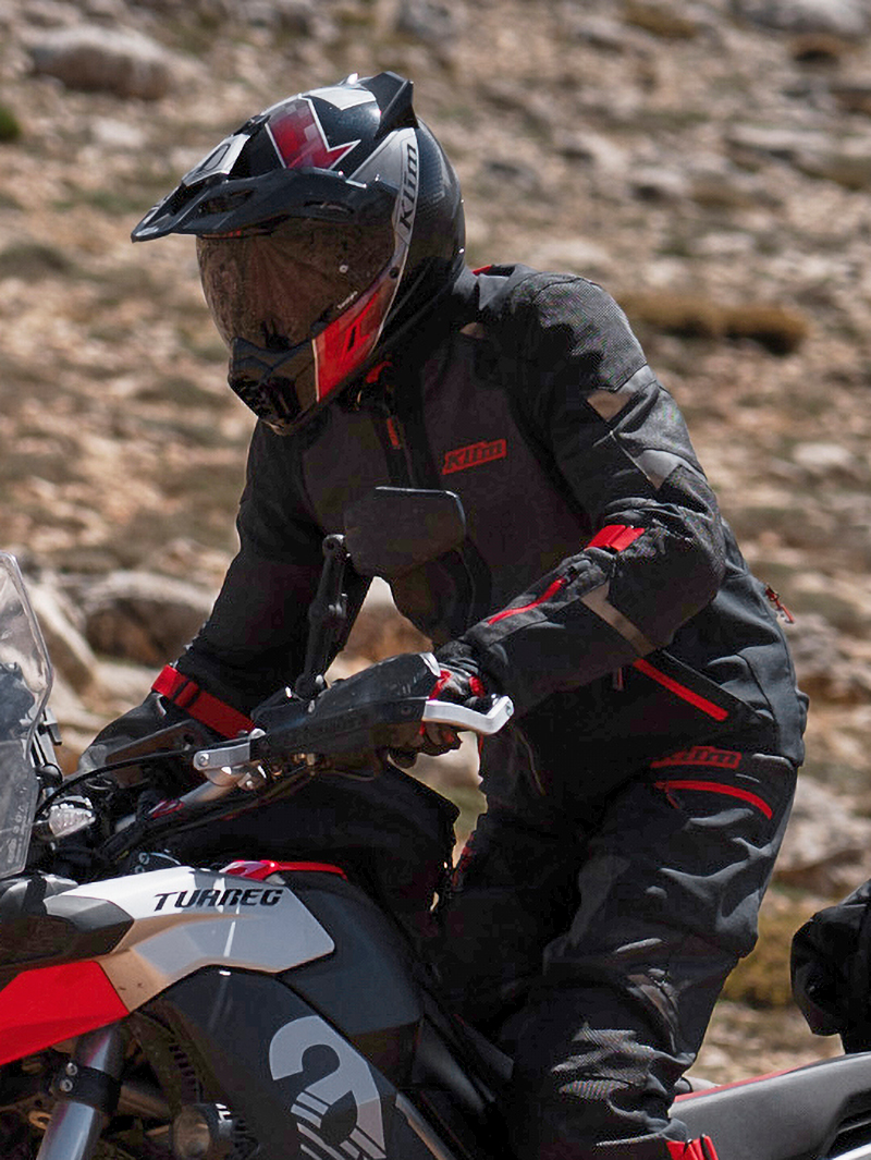 Guy wearing black and red Klim Baja S4 suit